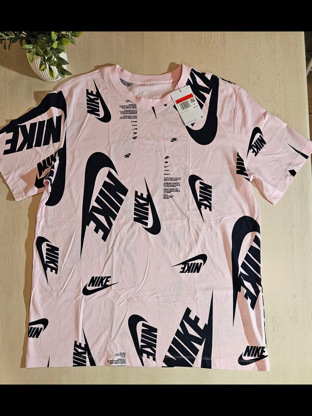 Nike Men’s Pink Tee with Black All-Over Swoosh Logos